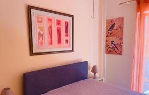 a bedroom with a bed and a picture on the wall at Villa Sofia in Chrani