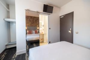 a hotel room with a bed and a bedroom at Kyriad Direct Limoges Nord in Limoges +43 photos