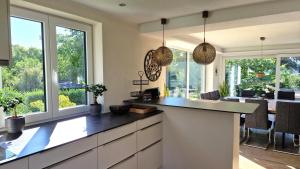 a kitchen with a counter and some windows at Ferienhaus Blütenlodge Bodensee in Lindau-Bodolz