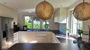 a kitchen with two chandeliers hanging from the ceiling at Ferienhaus Blütenlodge Bodensee in Lindau-Bodolz +55 photos