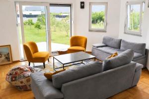 a living room with a couch and a table and chairs at Villa Nirvana in Mostar
