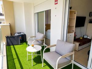 a living room with two chairs and a table at Salou Beach Apartment with private Pool in Salou