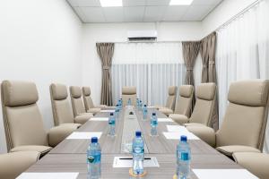 a conference room with a long table with bottles of water at Emirates Hotel in Ondangwa