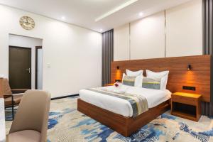 a bedroom with a bed and a desk and a chair at Emirates Hotel in Ondangwa +23 photos