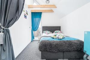 a bedroom with a bed with blue curtains at Słoneczne Domki in Rewal +21 photos