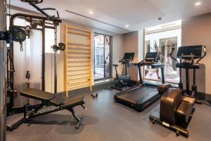 a gym with several treadmills and machines in a room at Catalonia Puerta del Mar in Málaga +39 photos