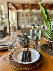 a wooden table with a plate and fork and knife at Agriturismo La Terrazza su Farfa in Castelnuovo di Farfa