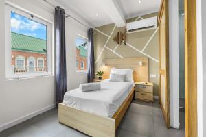 a small bedroom with a bed and a window at Art Hotel in Kralendijk