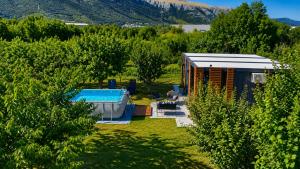 a garden with a house and a swimming pool at Resort-Music Mostar in Potoci