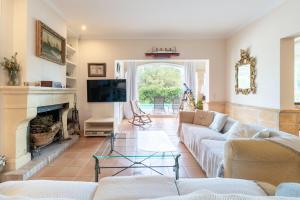 a living room with a couch and a fireplace at Villa Romana Bonaire in Cielo de Bonaire 