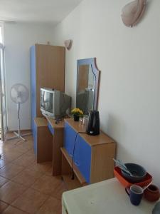 a living room with a tv and a mirror at Studio A in Sveti Vlas