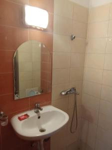a bathroom with a sink and a mirror at Studio A in Sveti Vlas +1 photo