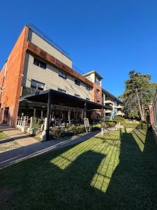 a building with a lawn in front of it at Pilar Suites by Viva in Pilar