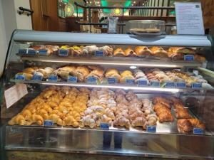 a display case in a bakery filled with lots of pastries at LaBienbi' in Cosenza