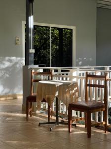 a table and chairs in a room with a window at Khao Yai Cottage in Mu Si +63 photos