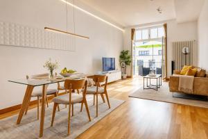 a dining room and living room with a table and chairs at Schwarzwald Loft Baden-Baden in Baden-Baden