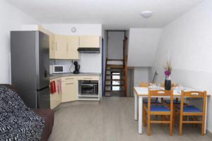 a kitchen and dining room with a table and a dining room at Beautiful cocoon with shared pool in Le Barcarès in Le Barcarès