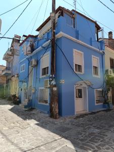 a blue building on the side of a street at Hidden gem agora flat Checkpoint-Mytilene in Mytilene