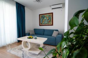 a living room with a blue couch and a table at Villa Milan in Sveti Stefan