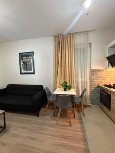 a living room with a couch and a table at My Sweet Apartment in Tbilisi City