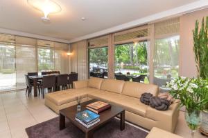 a living room with a couch and a table at Guest House Aštuoni in Palanga