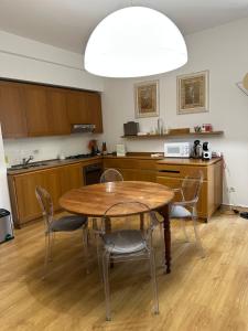 a kitchen with a table and chairs and a kitchen with a microwave at La Contessa - Lenno in Lenno +4 photos