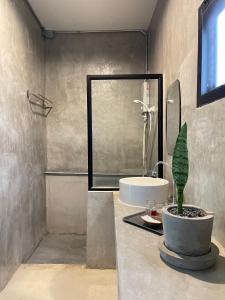 a bathroom with a sink and a shower and a sink at Khao Yai Cottage in Mu Si