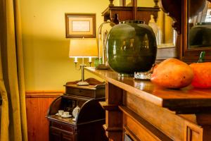 a kitchen with a counter with a large green vase on it at Royston Hall Historical Guesthouse in Umtentweni