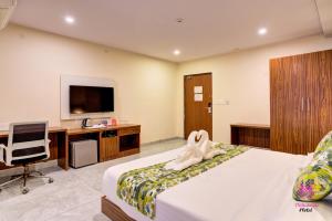 a hotel room with a bed with a towel at Millennials Hotel in Kammasandra