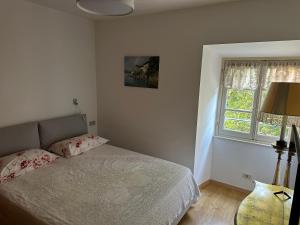 a bedroom with a bed and a window at La Contessa - Lenno in Lenno