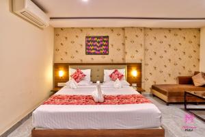a bedroom with a large bed and a couch at Millennials Hotel in Kammasandra