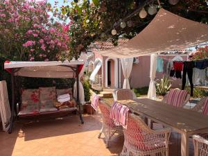 a patio with a table and chairs and a tent at Summer house Mokka in Silba