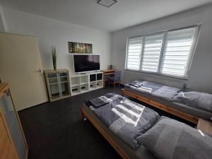 a room with two beds and a flat screen tv at Büdingen Hanau Frankfurt Monteurwohnung in Büdingen
