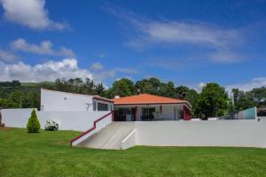 a house with a skateboard ramp in a yard at Chalé d'Angra Guest House in Angra do Heroísmo