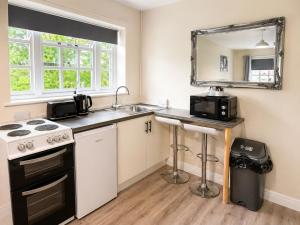 a small kitchen with a sink and a stove at The Hand Hotel in Chirk