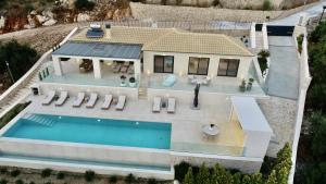 an aerial view of a house with a swimming pool at Apiron Luxury Villa in Agía Kyriakí +46 photos