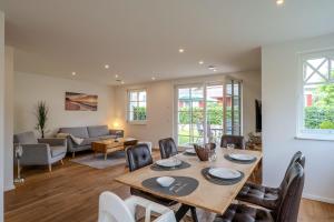 a dining room and living room with a table and chairs at Jade 1 in Born