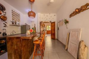 a kitchen with a counter and a row of stools at Casa Moraira in Cartagena de Indias