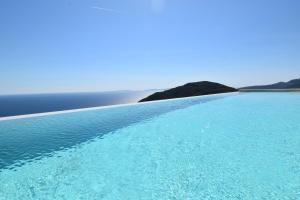 a large pool of blue water in the ocean at Apiron Luxury Villa in Agía Kyriakí