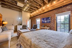 a bedroom with a large bed and a brick wall at Sweet Lancaster Apt. B in Lancaster