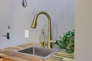a kitchen sink with a gold faucet at Sweet Lancaster Apt. B in Lancaster