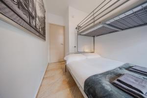 a bedroom with a large white bed in a room at Torre de Gracia Barcelona in Barcelona