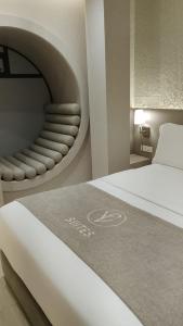 a rendering of a bedroom with a bed and a chair at VPV Suites & Casino in Medellín