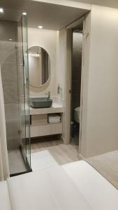 a bathroom with a sink and a mirror at VPV Suites & Casino in Medellín