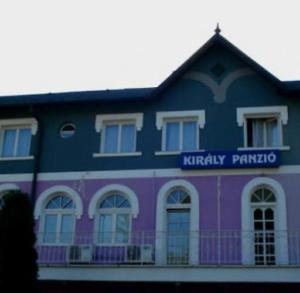 a blue and purple building with a sign on it at Király Szálló in Nagykanizsa