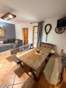 a living room with a wooden table and a couch at Uroczysko in Brenna