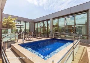 a swimming pool in the middle of a house at Living Sion in Belo Horizonte