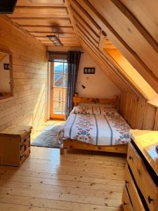 a bedroom with a bed in a wooden cabin at Uroczysko in Brenna