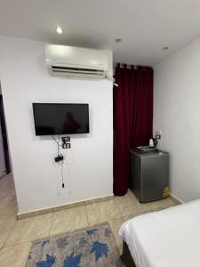 a room with a flat screen tv on the wall at Middle east panorama jacuzzi & spa in Cairo