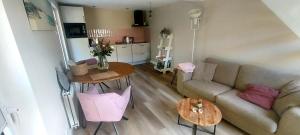 a living room with a couch and a table at De Strandloper in Petten +11 photos